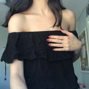 black cropped off the shoulder shirt